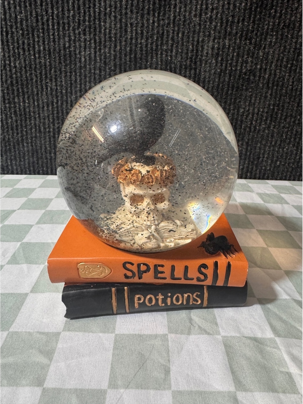 Decorative Skull and Raven Snow Globe on Spell and Potion Books